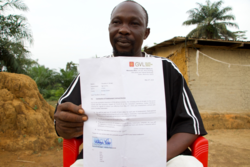 Medium_former-gvl-employee-timothy-browne-displays-his-letter-of-termination-in-butaw-sinoe-county